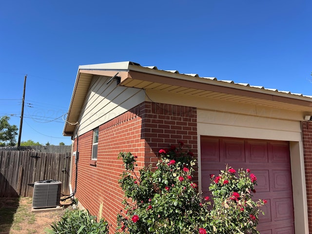 415 Mesquite Ave, Amarillo, TX 79108 - view of side of home featuring cooling unit, brick siding, fence, and metal roof