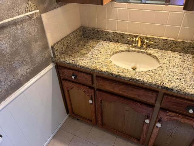 415 Mesquite Ave, Amarillo, TX 79108 - bathroom with vanity, tile patterned floors, wainscoting, a decorative wall, and backsplash