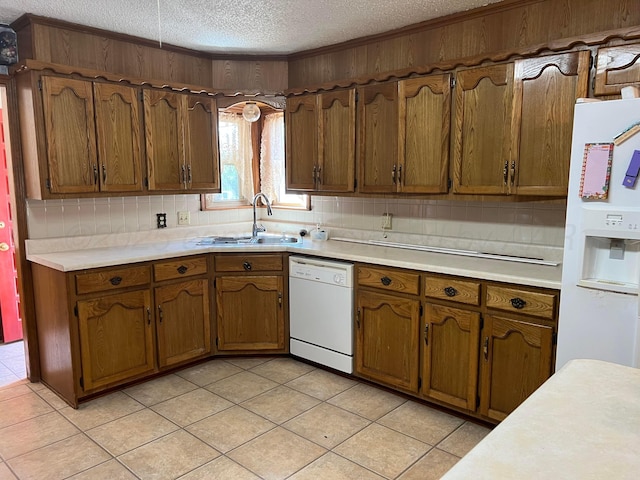 415 Mesquite Ave, Amarillo, TX 79108 - kitchen featuring white appliances, a sink, a textured ceiling, light countertops, and light tile patterned flooring