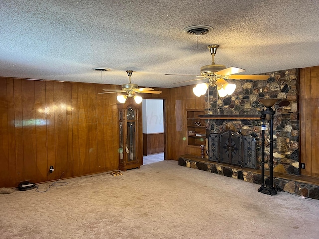 415 Mesquite Ave, Amarillo, TX 79108 - carpeted living room featuring ceiling fan, wooden walls, and a textured ceiling