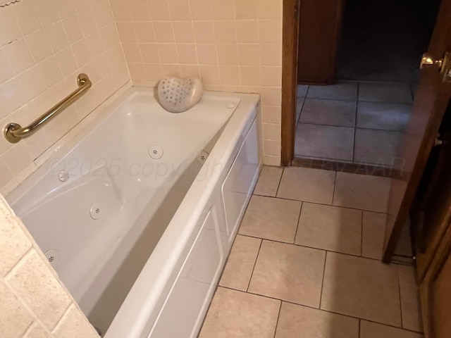415 Mesquite Ave, Amarillo, TX 79108 - bathroom featuring a jetted tub, tile patterned flooring, and tile walls
