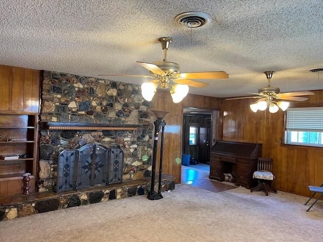 415 Mesquite Ave, Amarillo, TX 79108 - living room featuring carpet flooring, a ceiling fan, wood walls, and a textured ceiling