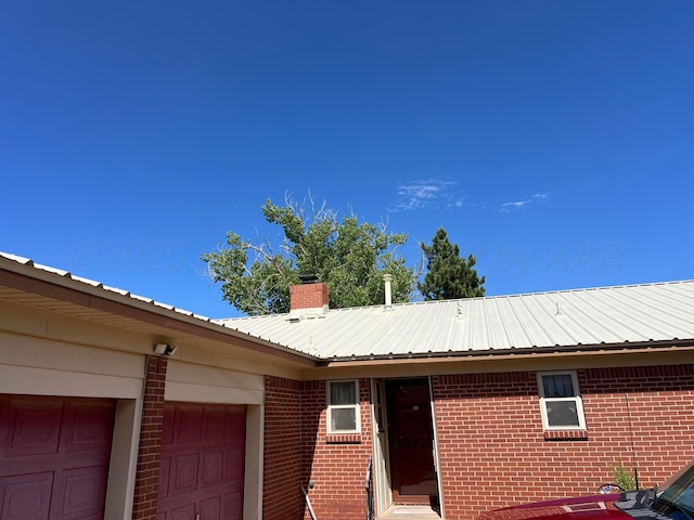 415 Mesquite Ave, Amarillo, TX 79108 - exterior view of metal roof, brick siding, and a chimney