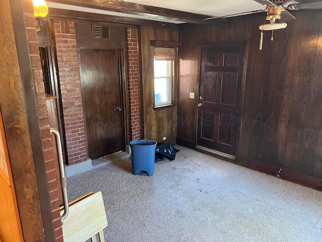 415 Mesquite Ave, Amarillo, TX 79108 - entrance foyer featuring carpet, ceiling fan, and wood walls