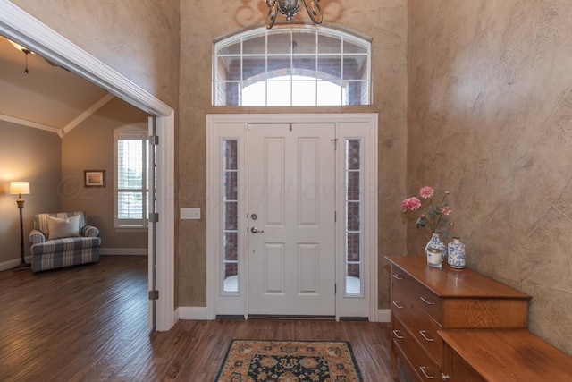 6600 Pepper Tree Pl, Amarillo, TX 79124 - foyer entrance with dark wood finished floors, a chandelier, high vaulted ceiling, and ornamental molding
