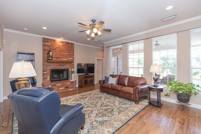 6600 Pepper Tree Pl, Amarillo, TX 79124 - living room featuring a ceiling fan, wood finished floors, a fireplace, ornamental molding, and recessed lighting