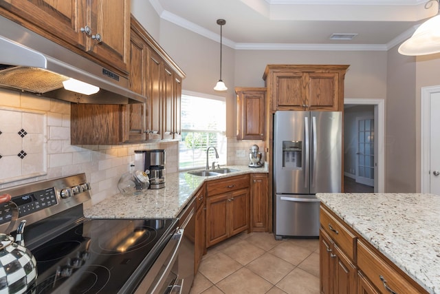 6600 Pepper Tree Pl, Amarillo, TX 79124 - kitchen with appliances with stainless steel finishes, under cabinet range hood, brown cabinets, and ornamental molding