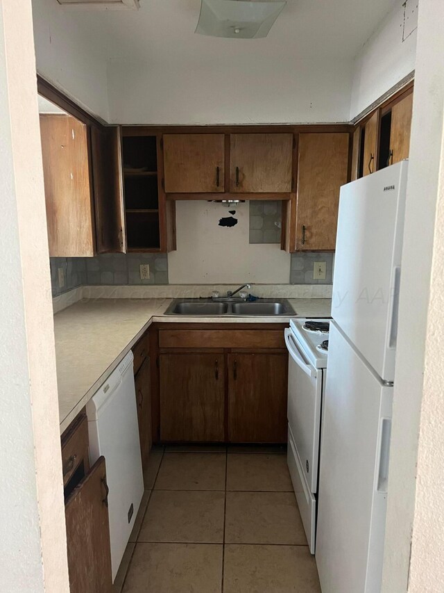 kitchen with range, a textured ceiling, light tile patterned floors, and white fridge