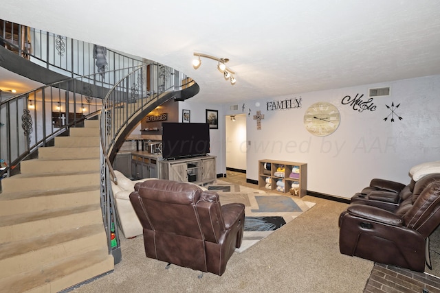 carpeted living room with track lighting