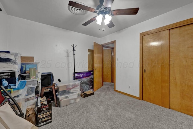 carpeted bedroom with a ceiling fan and a closet