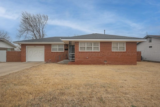 view of front of house featuring a garage, concrete driveway, brick siding, and a front lawn