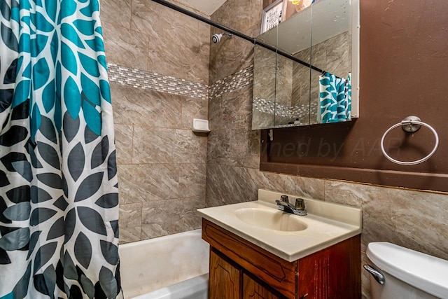 full bath featuring tile walls, shower / bath combo with shower curtain, toilet, and vanity