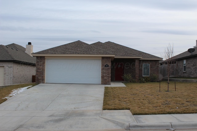 ranch-style house featuring a front yard and a garage