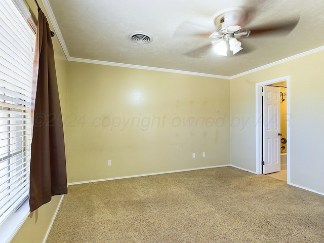 empty room featuring light carpet, plenty of natural light, crown molding, and ceiling fan