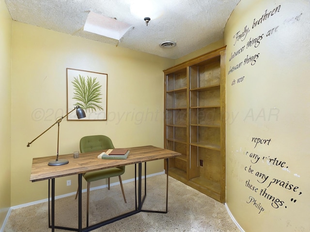 unfurnished office featuring a textured ceiling