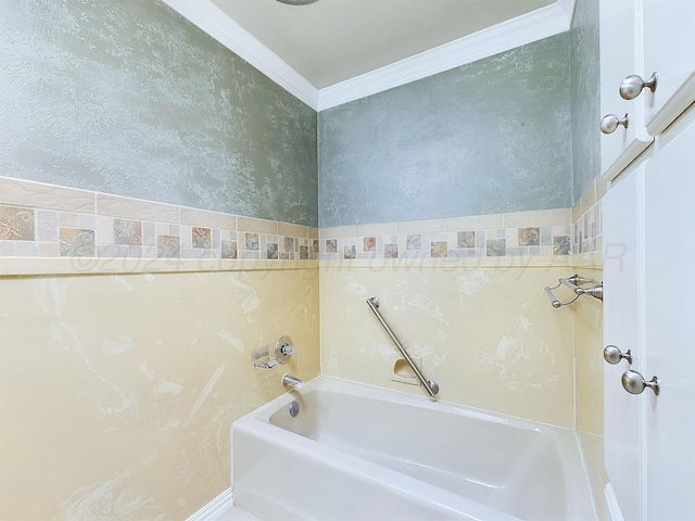 bathroom featuring a tub to relax in and crown molding