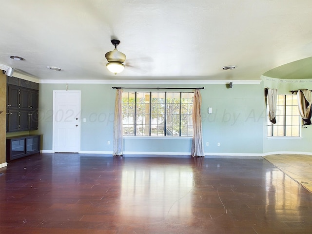 unfurnished living room with crown molding and dark hardwood / wood-style floors