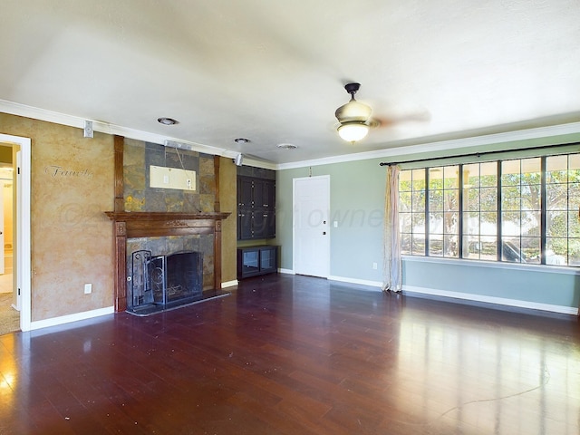 unfurnished living room featuring a fireplace, crown molding, and dark wood-type flooring