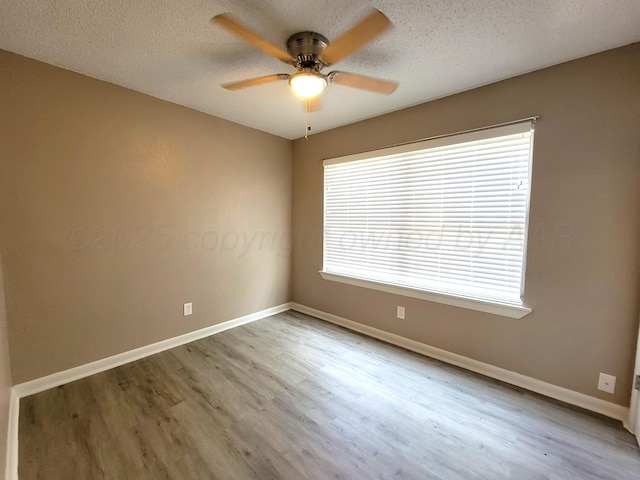 1312 Coffee St, Pampa, TX 79065 - empty room with ceiling fan, a textured ceiling, and hardwood / wood-style floors