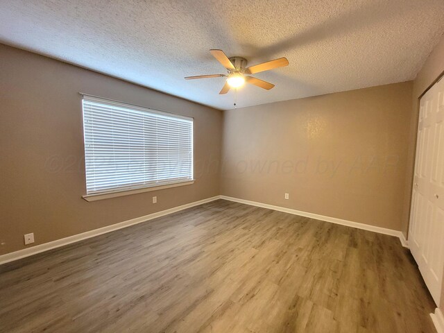 1312 Coffee St, Pampa, TX 79065 - spare room with a textured ceiling, hardwood / wood-style flooring, and ceiling fan