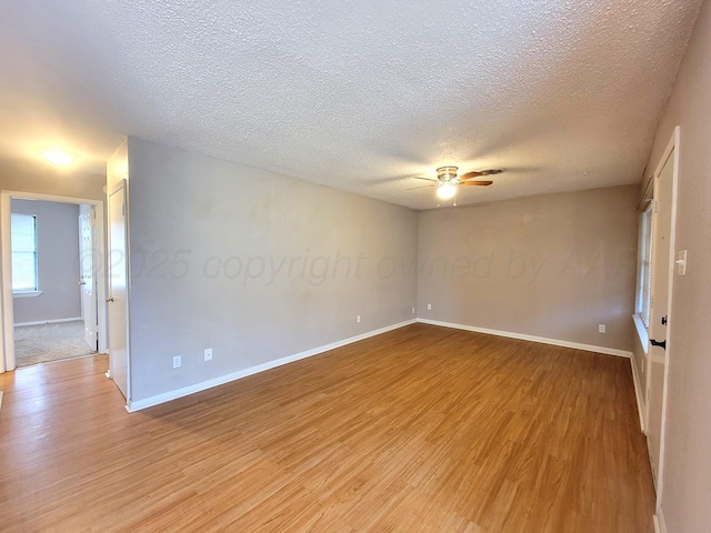 1312 Coffee St, Pampa, TX 79065 - empty room with ceiling fan, light hardwood / wood-style flooring, and a textured ceiling