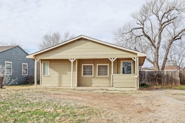 back of property featuring fence