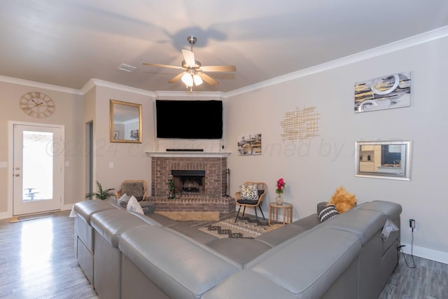 1738 Wesleyan St, Amarillo, TX 79118 - living room with a brick fireplace, hardwood / wood-style floors, ceiling fan, and crown molding