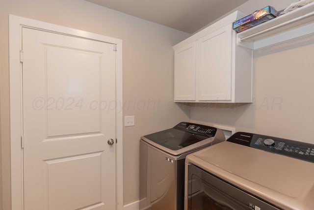 1738 Wesleyan St, Amarillo, TX 79118 - laundry room with washer and clothes dryer and cabinets