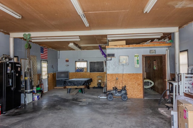 garage with black fridge