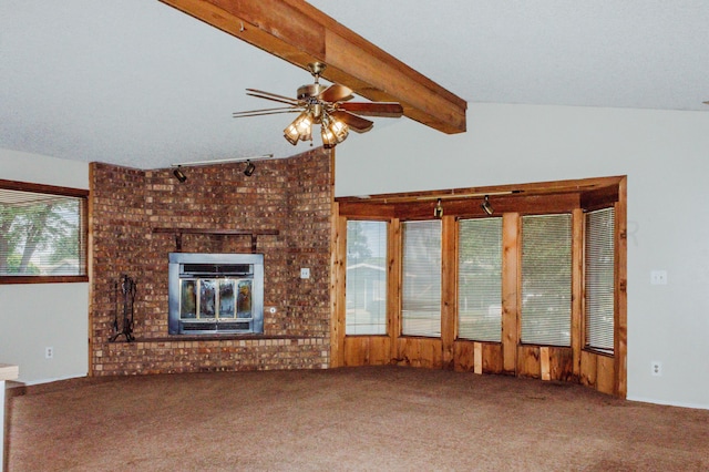 unfurnished living room featuring ceiling fan, a textured ceiling, carpet, vaulted ceiling with beams, and a brick fireplace