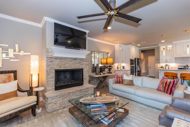 6900 Tatum Cir, Amarillo, TX 79119 - living room with ceiling fan, wood finished floors, crown molding, a stone fireplace, and recessed lighting