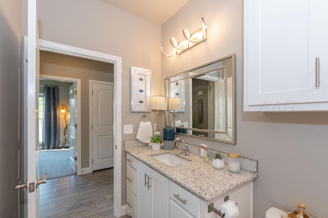 6900 Tatum Cir, Amarillo, TX 79119 - bathroom featuring vanity and wood finished floors