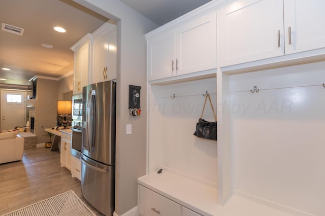 6900 Tatum Cir, Amarillo, TX 79119 - mudroom with light wood-type flooring, recessed lighting, and crown molding