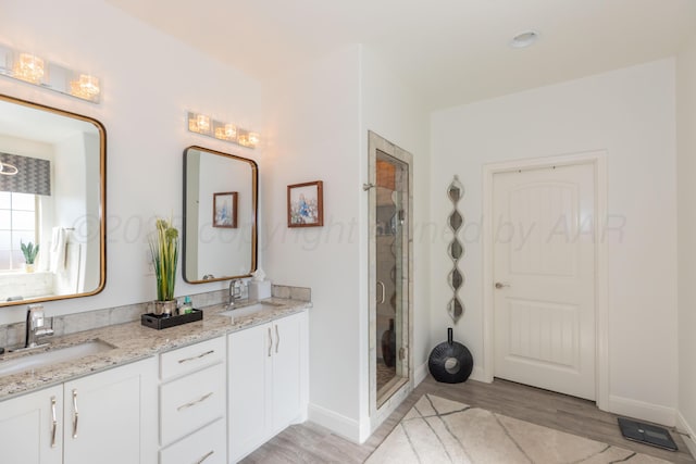 6900 Tatum Cir, Amarillo, TX 79119 - full bath with double vanity, wood finished floors, and a shower stall