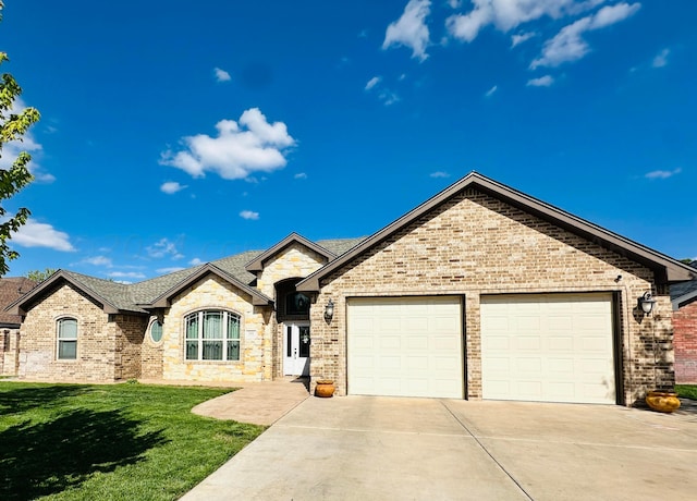 french country style house featuring a garage and a front lawn