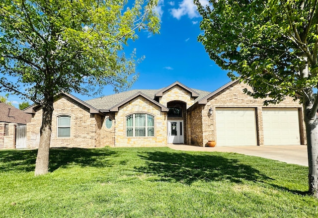 view of front of house with a garage and a front yard