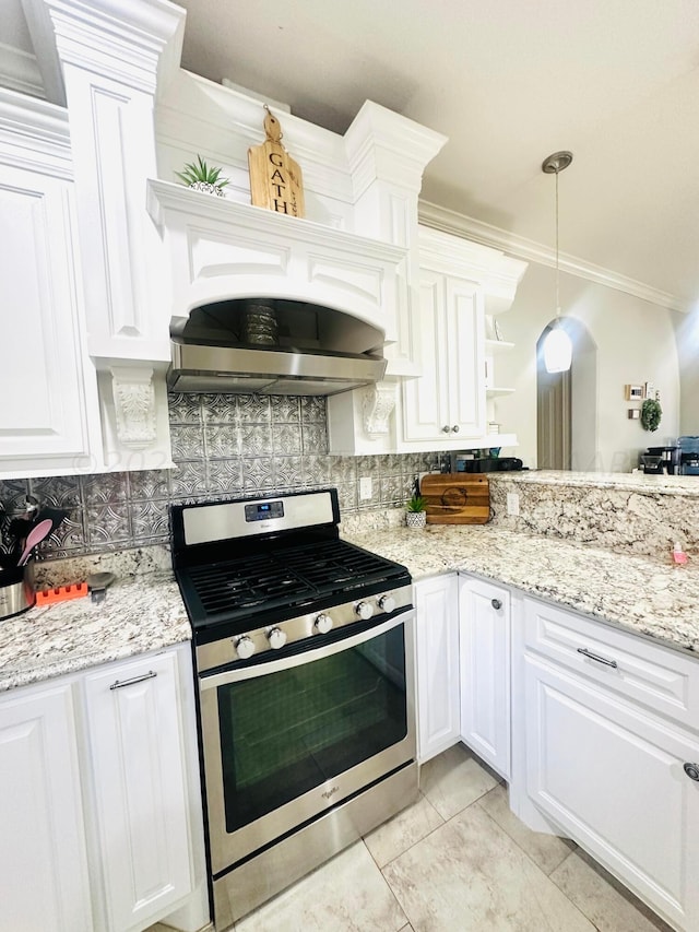 kitchen featuring tasteful backsplash, stainless steel range oven, ventilation hood, decorative light fixtures, and white cabinets