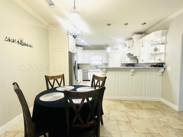 dining area featuring light tile patterned flooring, crown molding, and sink