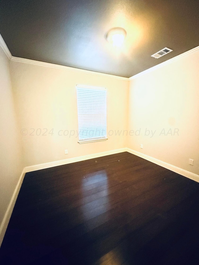 901 Melinda Ln, Dumas, TX 79029 - spare room with wood finished floors and ornamental molding