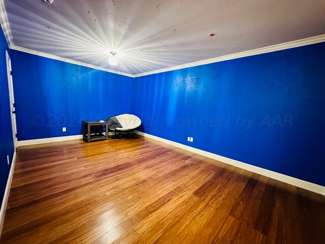 901 Melinda Ln, Dumas, TX 79029 - empty room featuring wood finished floors and crown molding