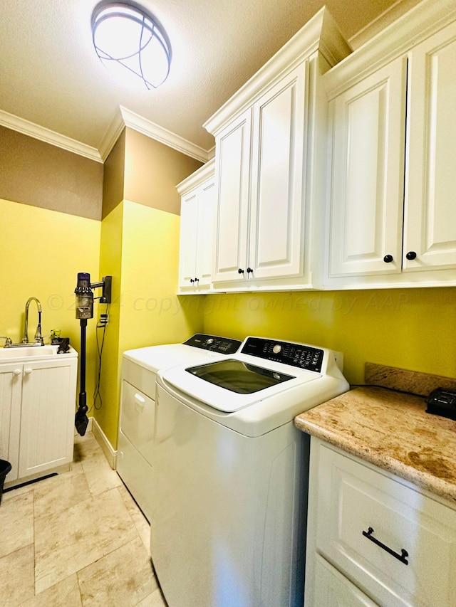 laundry area with cabinets, sink, ornamental molding, and independent washer and dryer