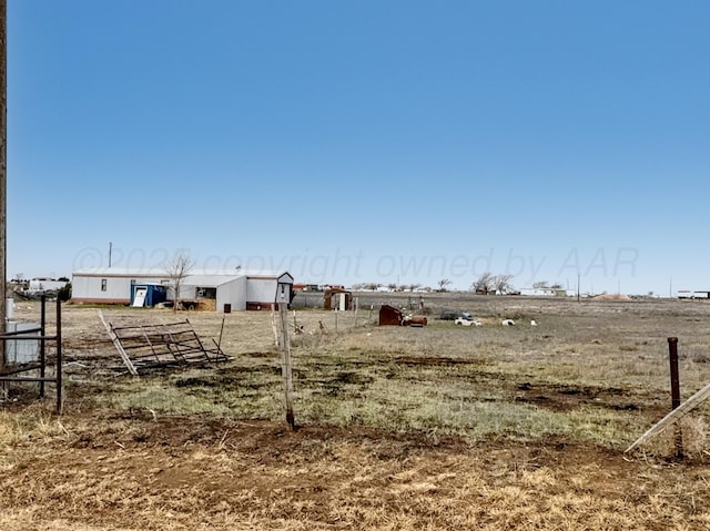 view of yard with a rural view