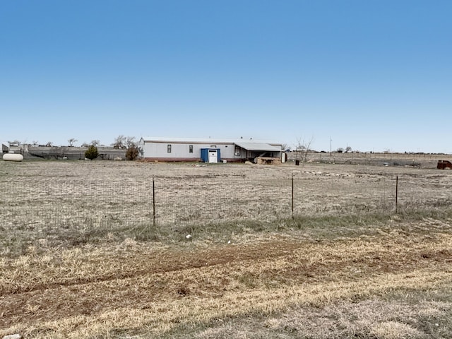 view of yard with a rural view and fence