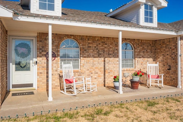 view of exterior entry with a porch