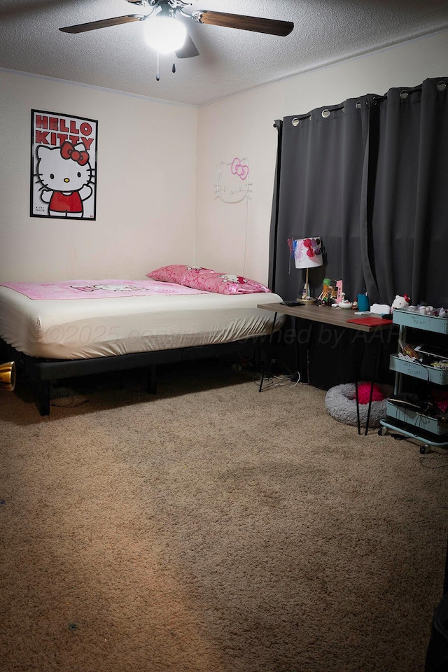 carpeted bedroom with ceiling fan and a textured ceiling