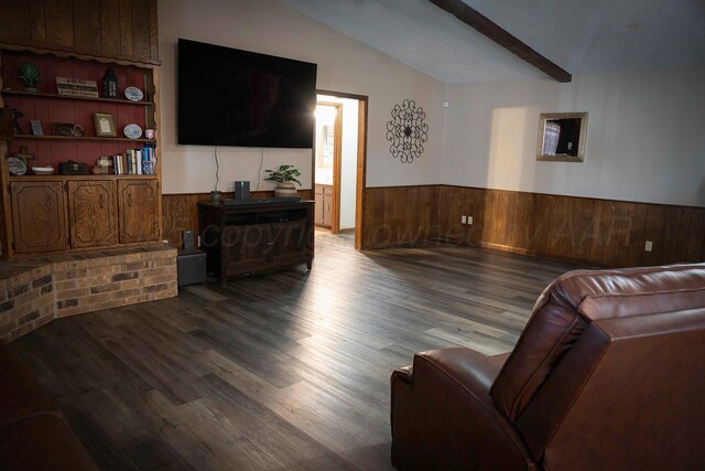 living room featuring wood walls, hardwood / wood-style floors, and vaulted ceiling with beams
