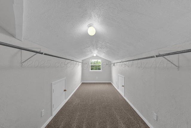 bonus room with a textured ceiling, vaulted ceiling, baseboards, and carpet flooring