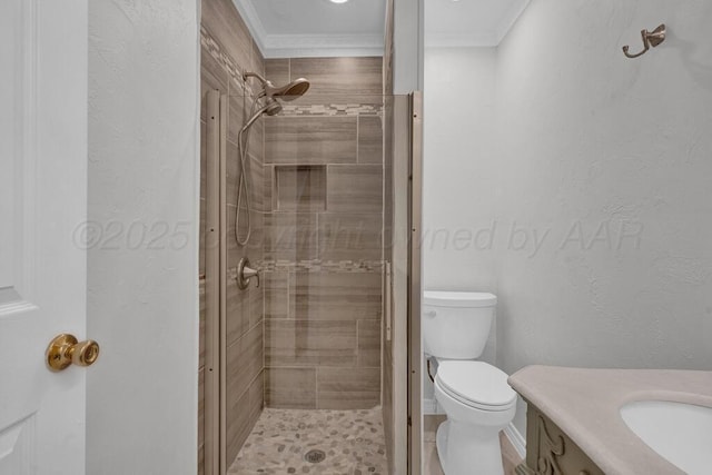 full bathroom with a stall shower, ornamental molding, toilet, vanity, and a textured wall