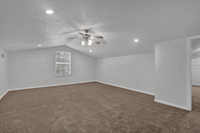 additional living space featuring dark carpet, a ceiling fan, vaulted ceiling, baseboards, and recessed lighting