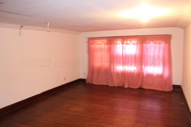 unfurnished room featuring wood finished floors and baseboards